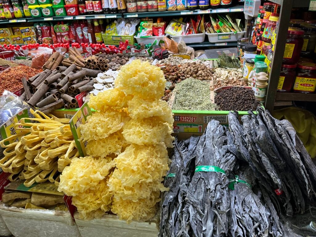 Shengfu Xiaoguan Market: Between Tradition, Everyday Life, and Change Traditional Chinese dry goods including white snow fungus, dried kelp, and cinnamon sticks at a local Beijing market.
