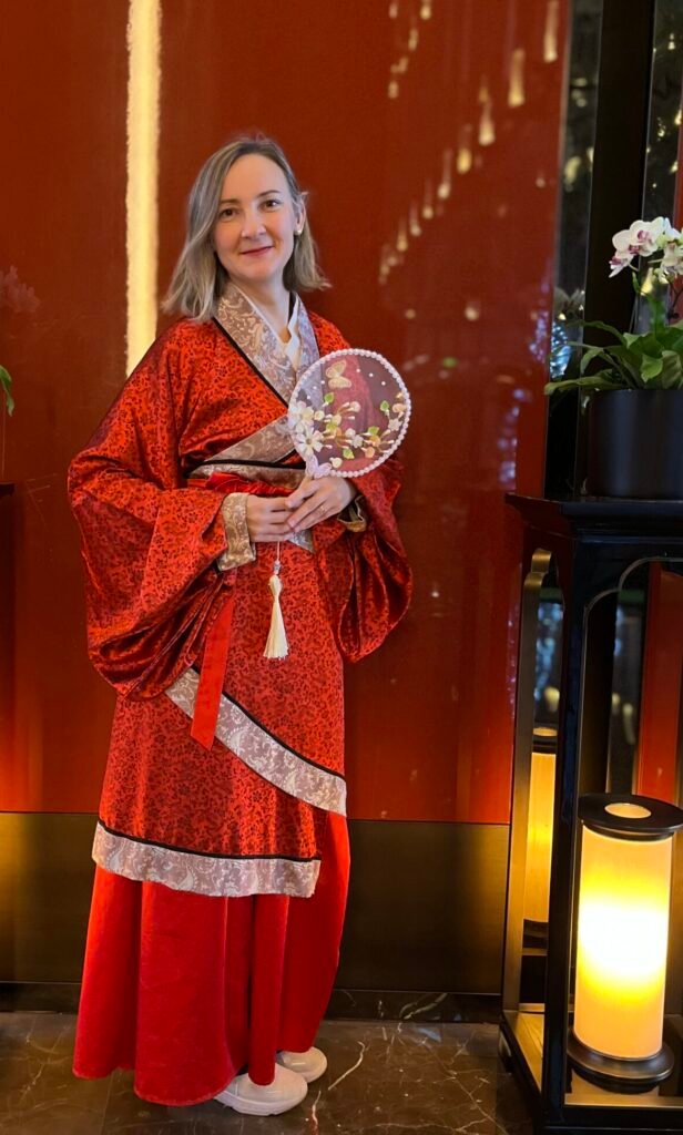 Hanfu in China: When Traditional Dress Moves through Modern Life Foreign author wearing traditional red Chinese Hanfu experiencing local culture in Beijing.