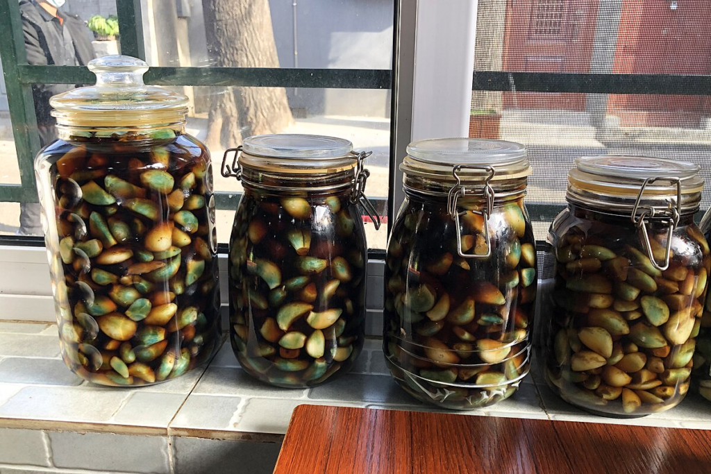 Laba Festival: A Bowl of Porridge, a Bite of Garlic — Spring Festival Is on the Way Glass jars filled with traditional green Laba garlic soaking in vinegar for the Chinese Laba Festival.